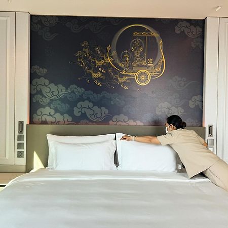 Hotel Grande Centre Point Surawong Bangkok Esterno foto A hotel maid making a bed